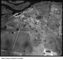A black and white photograph of Castledare taken from an aeroplane. Beside Castledare are the sinuous rills of the Canning River, and much of the riverfront has been cleared for agricultural purposes.