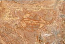 Ancient artwork depicting a tortoise, small portions of other animals can be seen painted around it out of frame.