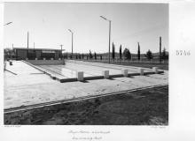 A black and white photograph of a half-empty swimming pool at Westbrook Training Centre. On the photograph is written: Works Department, July  ninetheen sixtyfive, Boys Home Westbrook, Swimming Pool.