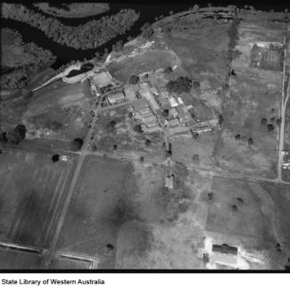 A black and white photograph of Castledare taken from an aeroplane. Beside Castledare are the sinuous rills of the Canning River, and much of the riverfront has been cleared for agricultural purposes.