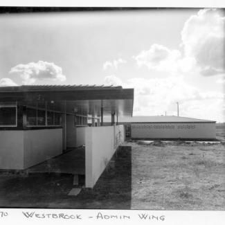A black and white photograph of buildings at Westbrook Training Centre. On the photograph is written: "May seventy, Westbrook, Admin Wing". 